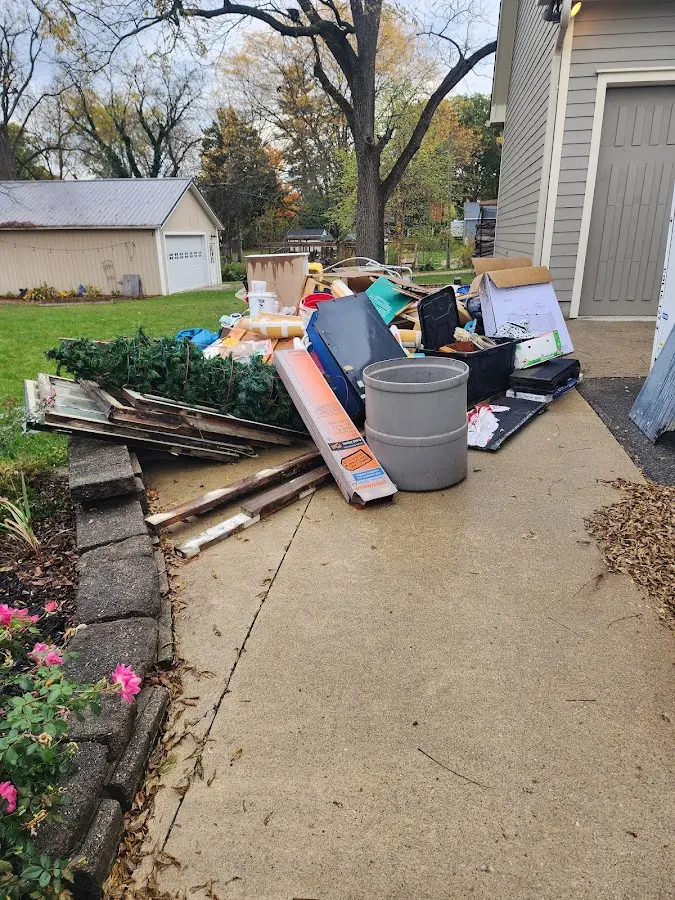 Dumpster being loaded with debris for Estate Cleanout Dumpster Rental in Heyburn